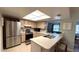 Well-lit kitchen boasts a breakfast bar, stainless steel appliances, and tiled floor at 1111 Harefield Cir, Sun City Center, FL 33573