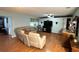 Spacious living room showcases wood floors, a ceiling fan, and a cozy sectional sofa at 1111 Harefield Cir, Sun City Center, FL 33573