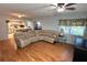 Inviting living room features an open floor plan, wood floors, and a comfortable sectional sofa at 1111 Harefield Cir, Sun City Center, FL 33573