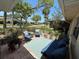 Inviting patio area with comfortable seating, potted plants, and a view of the landscaped yard at 1111 Harefield Cir, Sun City Center, FL 33573