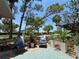 Outdoor patio featuring comfortable seating and lush tropical landscaping at 1111 Harefield Cir, Sun City Center, FL 33573