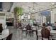 Large restaurant with hanging ivy, tree-trunk pillar and marble-topped tables with wood and padded chairs at 1111 Harefield Cir, Sun City Center, FL 33573