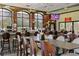 Open bar and grill area with lots of seating and natural light, with TVs on the walls at 1111 Harefield Cir, Sun City Center, FL 33573