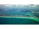 Stunning aerial view of a condo community on the Gulf of Mexico with beaches and a channel at 1115 Gulf Of Mexico Dr # 304, Longboat Key, FL 34228