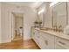 Elegant bathroom featuring double vanities with granite counters, wood floors and modern fixtures at 1115 Gulf Of Mexico Dr # 304, Longboat Key, FL 34228