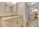 Bright bathroom vanity with granite counters and brushed gold fixtures open to a modern kitchen at 1115 Gulf Of Mexico Dr # 304, Longboat Key, FL 34228