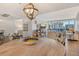 Bright dining area with wooden table and tropical themed chairs, perfect for entertaining at 1115 Gulf Of Mexico Dr # 304, Longboat Key, FL 34228