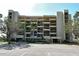 Exterior of a multi-story condo building with multiple balconies and well-maintained landscaping at 1115 Gulf Of Mexico Dr # 304, Longboat Key, FL 34228