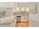 Spacious kitchen features granite countertops, stainless appliances and wood flooring at 1115 Gulf Of Mexico Dr # 304, Longboat Key, FL 34228
