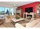 Comfortable living room with fireplace, TV, and ocean view through large windows at 1115 Gulf Of Mexico Dr # 304, Longboat Key, FL 34228