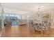 Open-concept living and dining area with hardwood floors and access to a scenic balcony at 1115 Gulf Of Mexico Dr # 304, Longboat Key, FL 34228