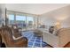 Cozy living room featuring comfortable seating, a stylish rug, and sliding doors to a balcony at 1115 Gulf Of Mexico Dr # 304, Longboat Key, FL 34228