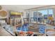 Comfortable living room with large TV, stylish furniture, and a balcony overlooking the water at 1115 Gulf Of Mexico Dr # 304, Longboat Key, FL 34228