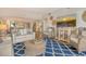 Comfortable living room featuring a blue patterned rug and wicker furniture for a relaxed atmosphere at 1115 Gulf Of Mexico Dr # 304, Longboat Key, FL 34228