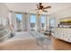 Comfortable main bedroom with white furnishings and floor-to-ceiling windows for natural light and views at 1115 Gulf Of Mexico Dr # 304, Longboat Key, FL 34228