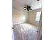 Light-filled bedroom with a ceiling fan, neutral carpet, and a window at 119 Maraviya Blvd, Nokomis, FL 34275