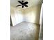 Bedroom featuring a ceiling fan, neutral carpet, closet, and a window at 119 Maraviya Blvd, Nokomis, FL 34275