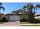 Charming single-story home with a brick driveway, two-car garage, and lush landscaping at 119 Maraviya Blvd, Nokomis, FL 34275