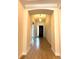 Elegant foyer featuring tray ceiling, decorative lighting, and tile flooring at 119 Maraviya Blvd, Nokomis, FL 34275