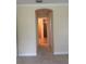 Hallway with neutral walls and carpet, leading to the bathroom with a glass shower at 119 Maraviya Blvd, Nokomis, FL 34275