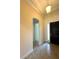 Hallway leading to the front door featuring neutral walls and tile flooring at 119 Maraviya Blvd, Nokomis, FL 34275