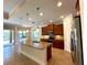 Open kitchen with granite counters, stainless appliances and an island with a sink at 119 Maraviya Blvd, Nokomis, FL 34275
