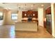 Well-equipped kitchen with granite countertops, center island, stainless steel appliances, and modern fixtures at 119 Maraviya Blvd, Nokomis, FL 34275