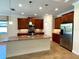 Modern kitchen featuring granite countertops, stainless steel appliances, and a large island at 119 Maraviya Blvd, Nokomis, FL 34275