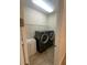 Laundry room with a washer and dryer, a sink, and storage shelves at 119 Maraviya Blvd, Nokomis, FL 34275