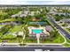 Community aerial view showcasing community pool and amenity center, tennis courts, and lush landscaping in a prime location at 12327 Halfmoon Lake Ter, Bradenton, FL 34211