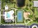Aerial view features neighborhood pool, amenity center, tennis and pickle ball courts, playground, and serene community ponds at 12327 Halfmoon Lake Ter, Bradenton, FL 34211