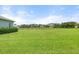 Expansive backyard offers serene views of the neighborhood pond and mature landscaping, perfect for relaxation and outdoor activities at 12327 Halfmoon Lake Ter, Bradenton, FL 34211