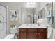 Bright bathroom features a large vanity and decorative art and a glass enclosed shower at 12327 Halfmoon Lake Ter, Bradenton, FL 34211