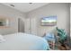 Comfortable bedroom with a queen bed, neutral walls, and a mounted television at 12327 Halfmoon Lake Ter, Bradenton, FL 34211