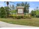 Inviting entrance to Eagle Trace community featuring lush landscaping and a prominent brick sign, creating a welcoming atmosphere at 12327 Halfmoon Lake Ter, Bradenton, FL 34211