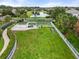 Aerial view of a community dog park with training obstacles and green space near a pond at 12327 Halfmoon Lake Ter, Bradenton, FL 34211
