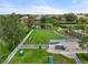 Community dog park with various agility equipment, walking paths, and a shaded bench at 12327 Halfmoon Lake Ter, Bradenton, FL 34211