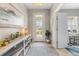 Elegant entryway with stylish decor, showcasing a welcoming atmosphere and access to the home office at 12327 Halfmoon Lake Ter, Bradenton, FL 34211