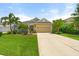 Charming single-story home with a well-manicured lawn, mature landscaping, and a two-car garage at 12327 Halfmoon Lake Ter, Bradenton, FL 34211