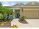 Inviting home facade featuring a covered entry, manicured landscaping, and a warm, welcoming ambiance at 12327 Halfmoon Lake Ter, Bradenton, FL 34211