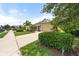 Charming home with well-kept lawn, mature landscaping, and a paved driveway at 12327 Halfmoon Lake Ter, Bradenton, FL 34211