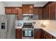 Modern kitchen features stainless steel appliances, white subway tile backsplash and dark wood cabinets at 12327 Halfmoon Lake Ter, Bradenton, FL 34211