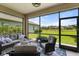 Screened in lanai features comfortable seating with a beautiful view of the greenbelt at 12327 Halfmoon Lake Ter, Bradenton, FL 34211