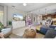 Spacious living area with open layout featuring a comfortable sectional, dining area, and well-equipped kitchen at 12327 Halfmoon Lake Ter, Bradenton, FL 34211