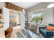 Bright home office showcasing a functional layout with a large window and comfortable furnishings at 12327 Halfmoon Lake Ter, Bradenton, FL 34211