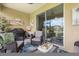 Covered patio featuring comfortable seating, a Weber grill, and sliding glass doors to seamlessly blend indoor and outdoor living at 12327 Halfmoon Lake Ter, Bradenton, FL 34211