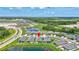 Gorgeous aerial view of the property's serene setting, complete with a tranquil pond nearby at 12743 Tahitian Pearl Cir, Parrish, FL 34219