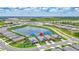 Aerial view of lakefront neighborhood with well-maintained homes and vibrant community spaces at 12743 Tahitian Pearl Cir, Parrish, FL 34219