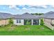 Well-maintained backyard featuring lush green lawn, young trees, and a screened in porch at 12743 Tahitian Pearl Cir, Parrish, FL 34219