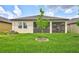 Spacious backyard with lush green grass and a screened-in lanai, great for entertaining at 12743 Tahitian Pearl Cir, Parrish, FL 34219